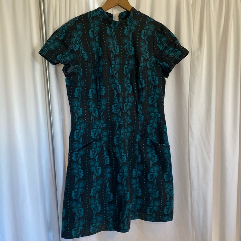 Charcoal dress with teal buttercup pattern.